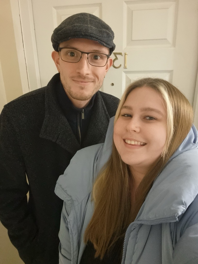 Bethanie-Taylor and Gregory at their front door